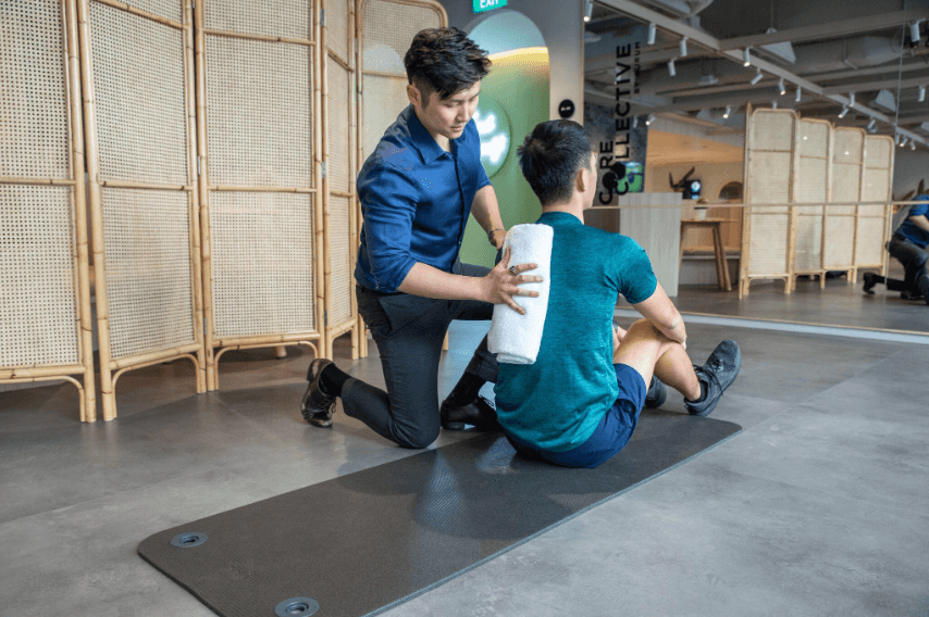 Dr. Tim Foo guiding a patient through a rehabilitation exercise